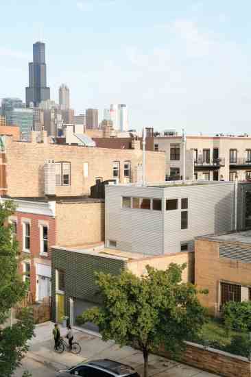 The urban infill site’s proximity to neighbors and businesses ensures Frances and Jim stay connected with the local community. Jim says the visible solar arrays and wind turbines help engage neighbors and passersby, who stop to ask about their rooftop “sculptures.”